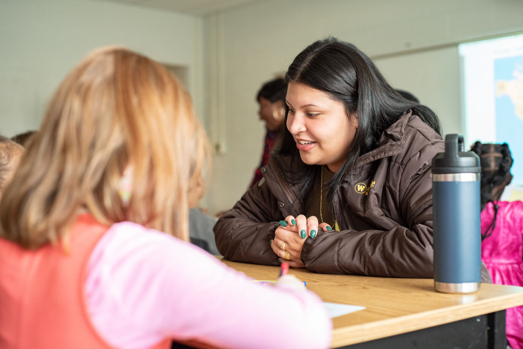 UNIDOS volunteer interacts with elementary student